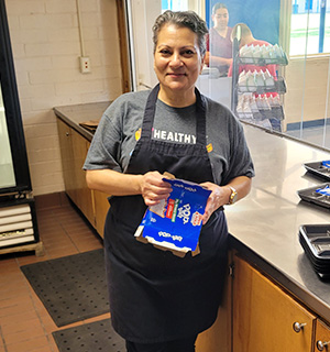 Staff person at counter holding a PopTart box